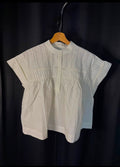 Blouse blanche en coton à broderies ajourées